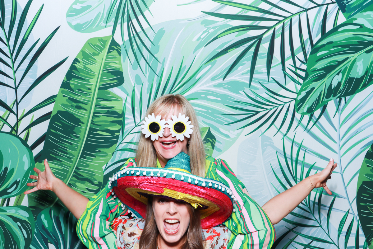 tropical backdrop for a photo booth wedding event at stone barn cotswolds