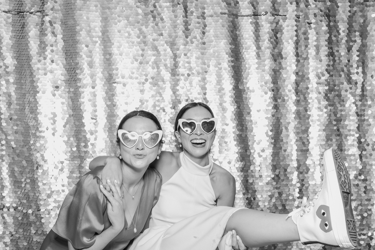 bride and guest with heart shaped glasses for a cotswolds wedding party