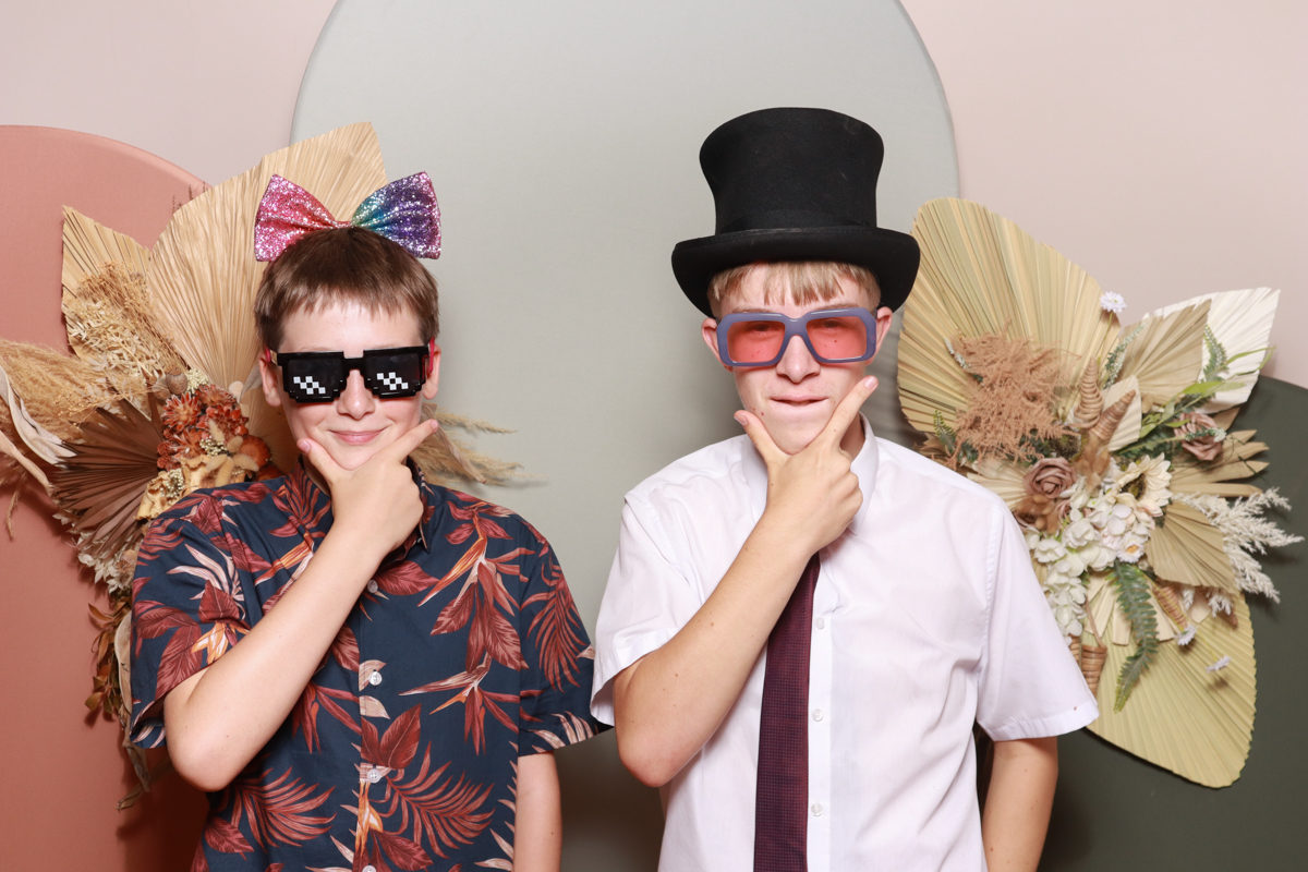 kids using the photo booth setup during a wedding at the barn at upcote