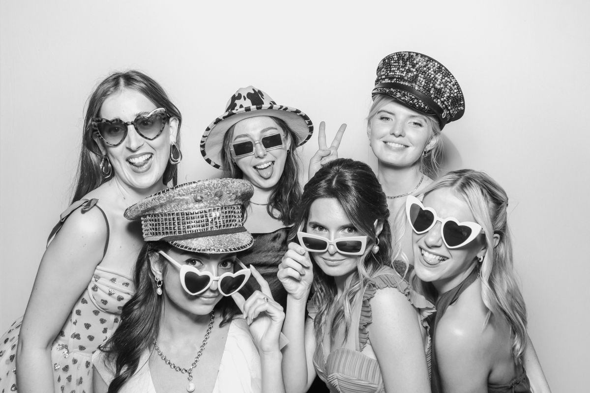 girls posing with sunglasses and props during a photo booth party entertainment cotswolds