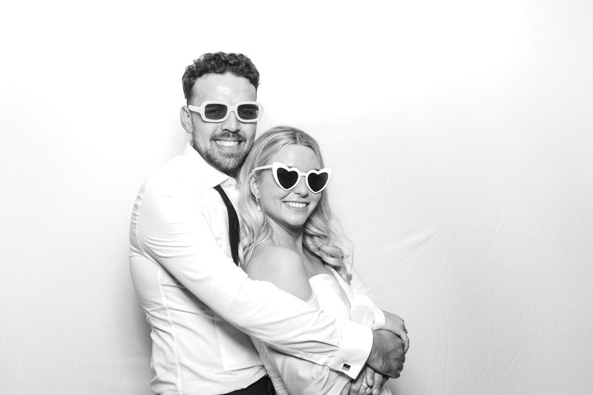 white background for a black and white photo booth with bride and groom posing for a photo booth hire cotswolds 