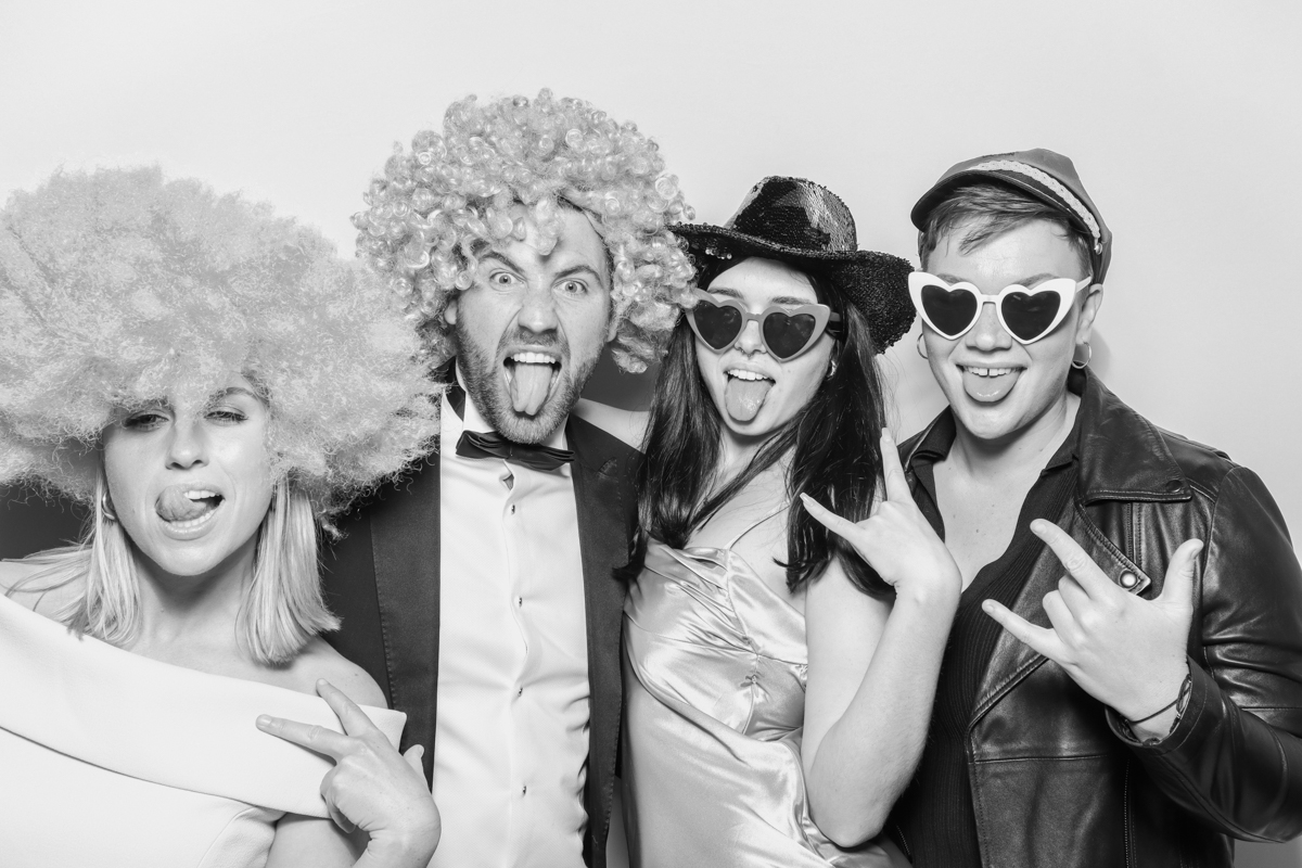 wedding guests posing for a fun photo booth party entertainment