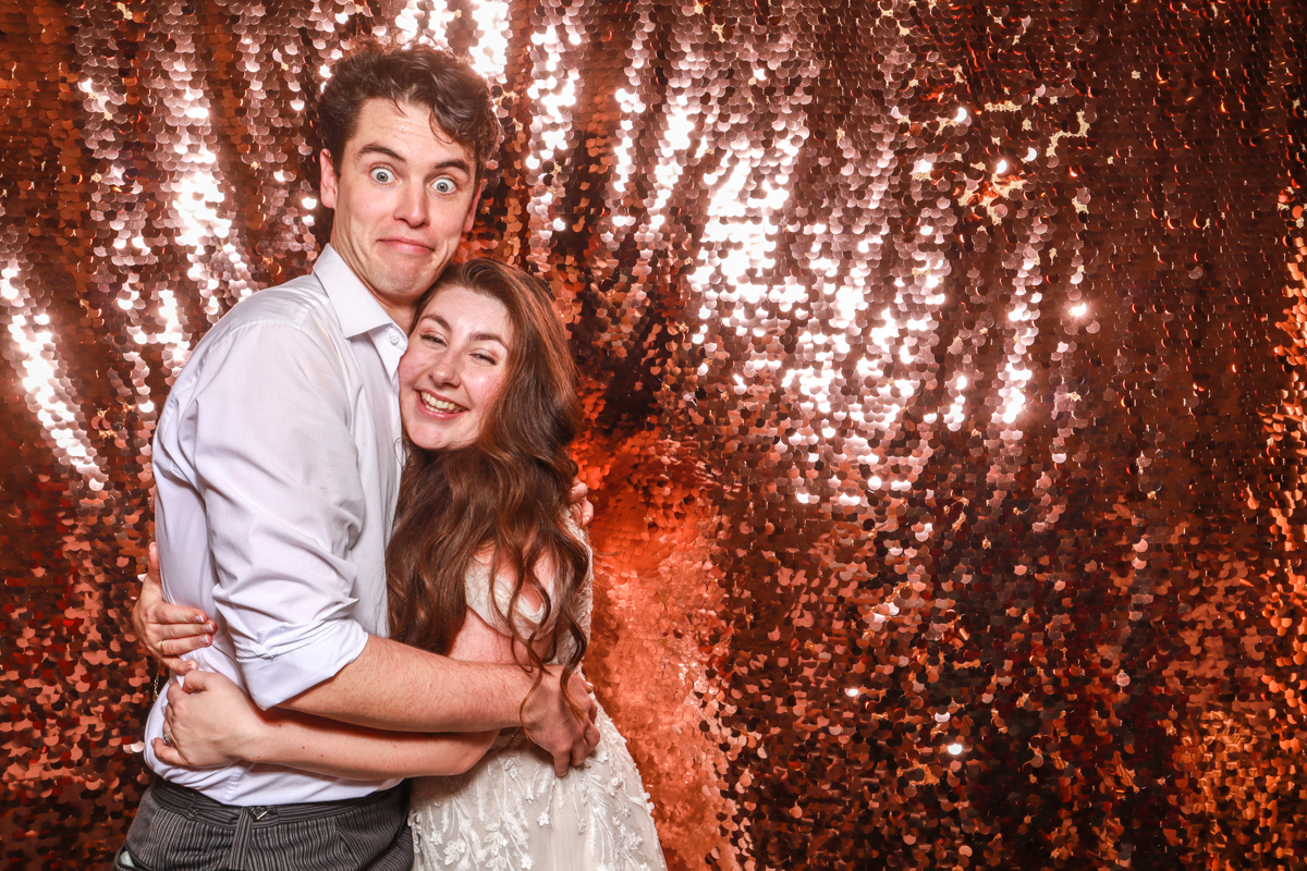 bride and groom during their wedding entertainment at Oxleaze Barn photo booth hire