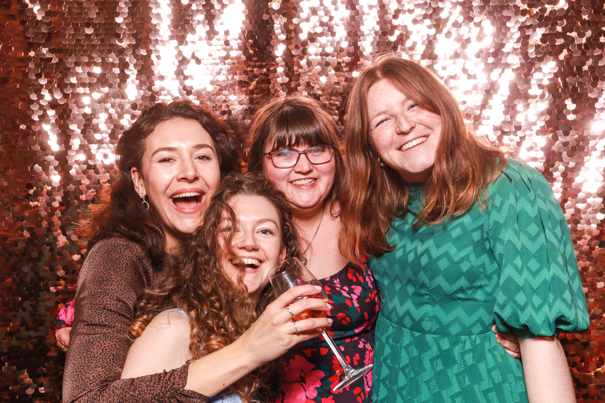 wedding guests having photos taken at Oxleaze barn photo booth party entertainment