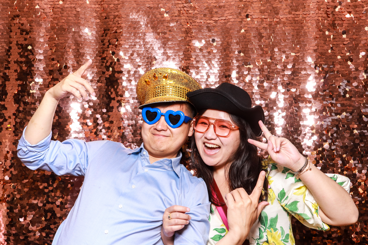 couple having fun during a wedding entertainment with mad hat photo booth