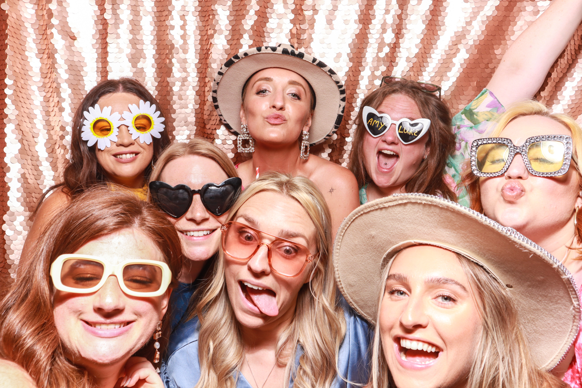 group photo with a fun sequins backdrop during a wedding reception