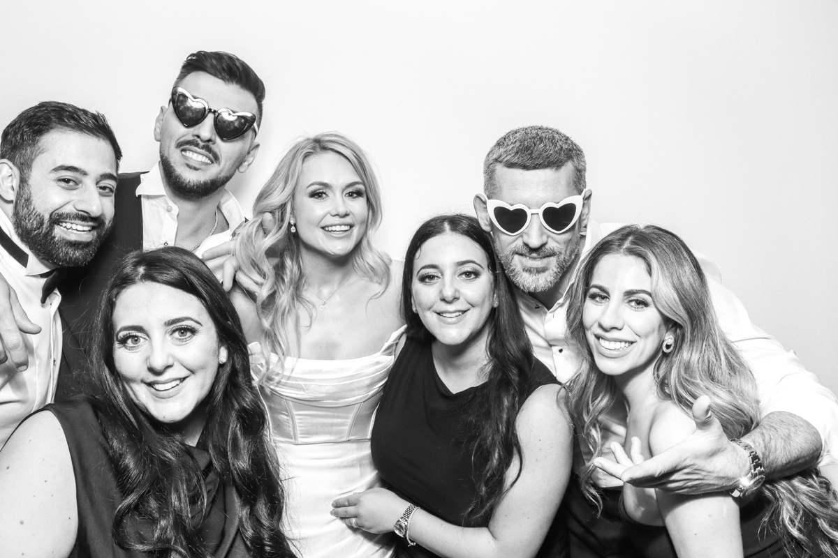 bride and friends posing for a kardashian style photo booth