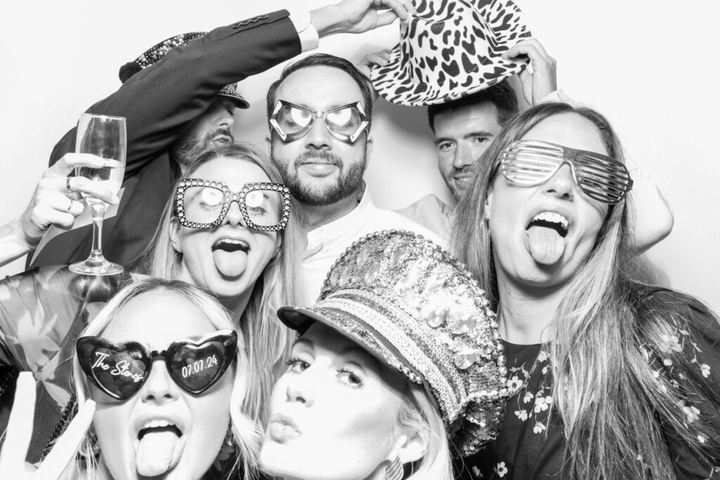 a large group of guests during a party entertainment posing for a photo booth hire 