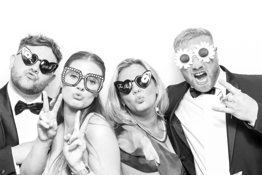 4 guests during a Photo Booth Hire in Leicester  for a wedding party entertainment with a b&w filter