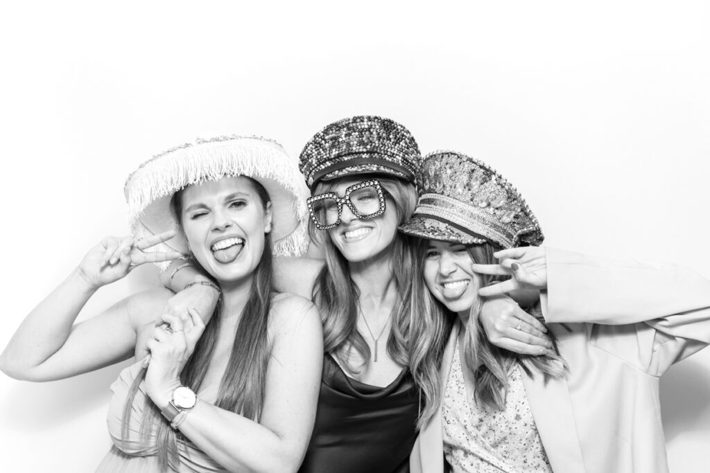 3 guests during a Photo Booth Hire in Leicester  for a wedding party entertainment with a b&w filter
