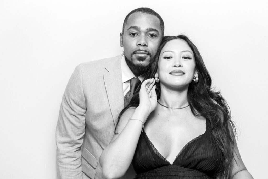 a couple posing during a Photo Booth Hire in Leicester  for a wedding party entertainment with a b&w filter