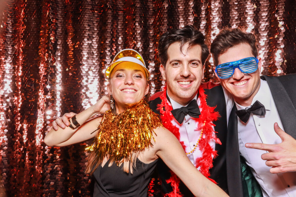 3 guests with fun props and heart shaped glasses during a photo booth hire party entertainment in cotswolds