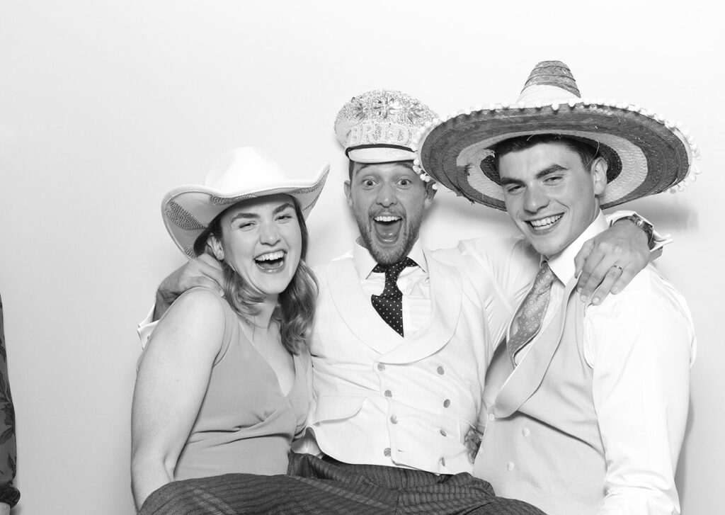 3 guests posing for brand party entertainment with a black and white filter on, for a Photo Booth With Email Collection Feature