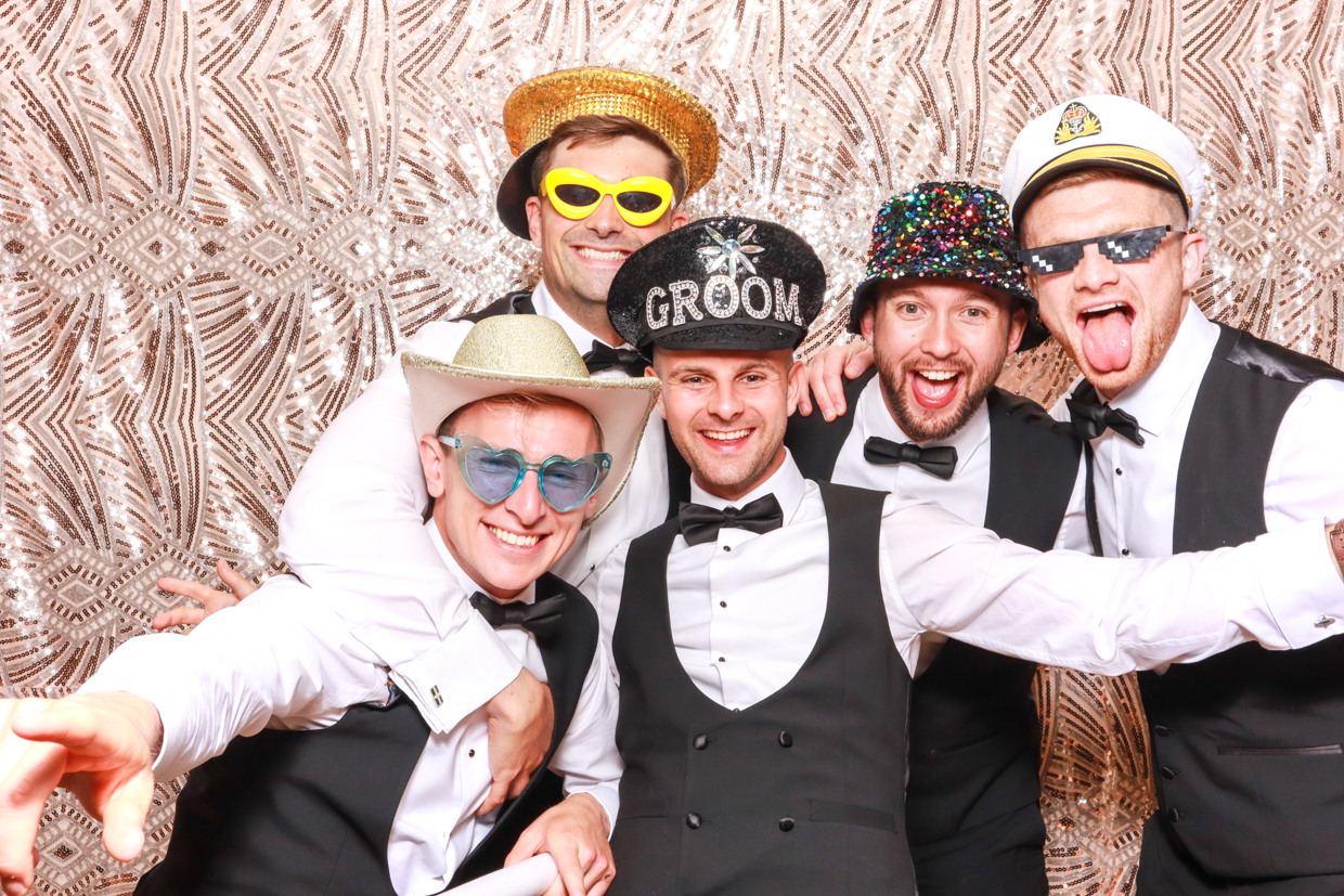 a large group of guys posing with a boho sequins backdrop during a party entertainment photo booth hire