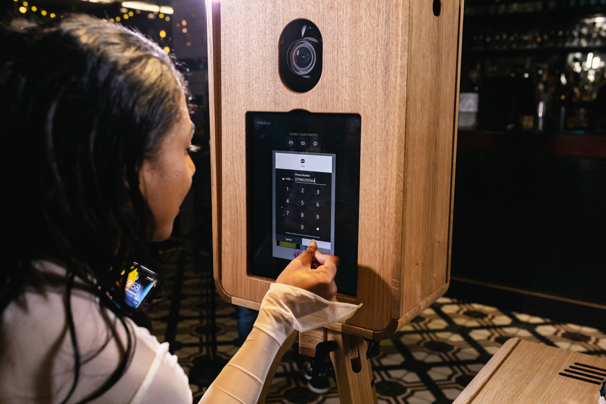 lady introducing her phone number for marketing purposes, during a corporate event photo booth hire