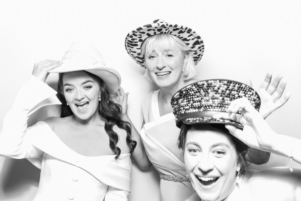 black and white print of 3 guests against a white backdrop, , during a party entertainment event in the cotswolds