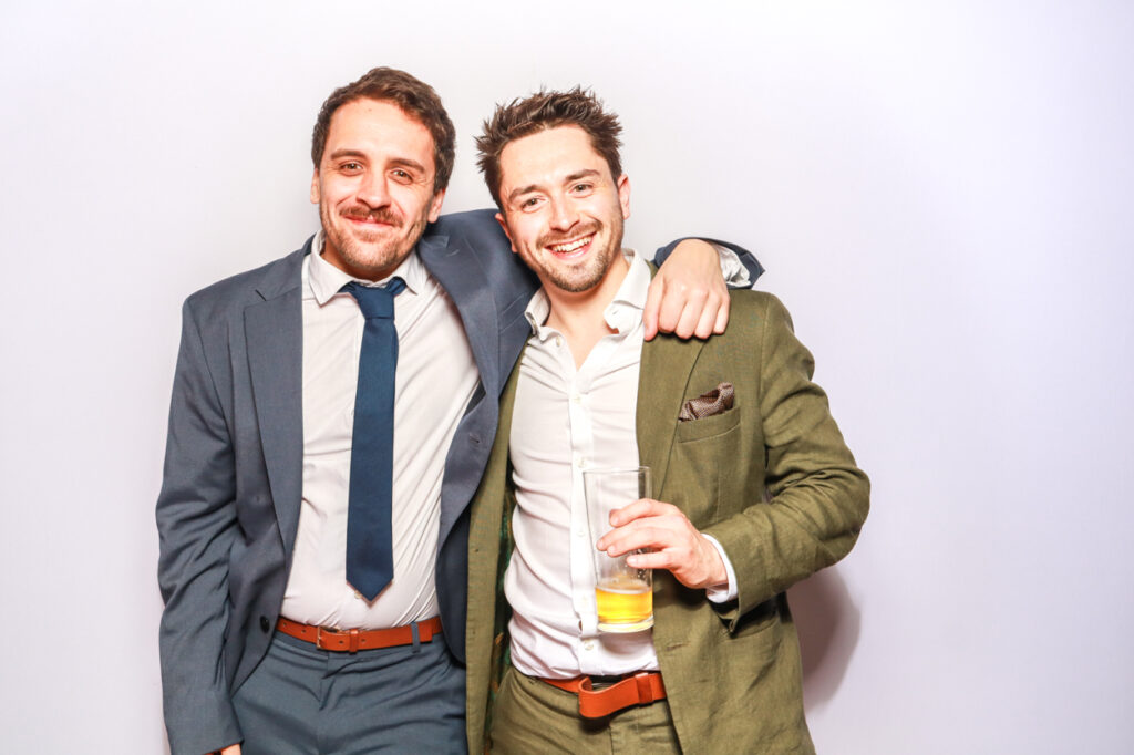 2 guests during a corporate event rental entertainment for brands posing against a white backdrop