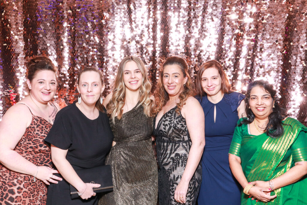 a group of ladies beautifully dressed in colourful dresses, during a NHS Staff Awards event at Cheltenham racecourse 