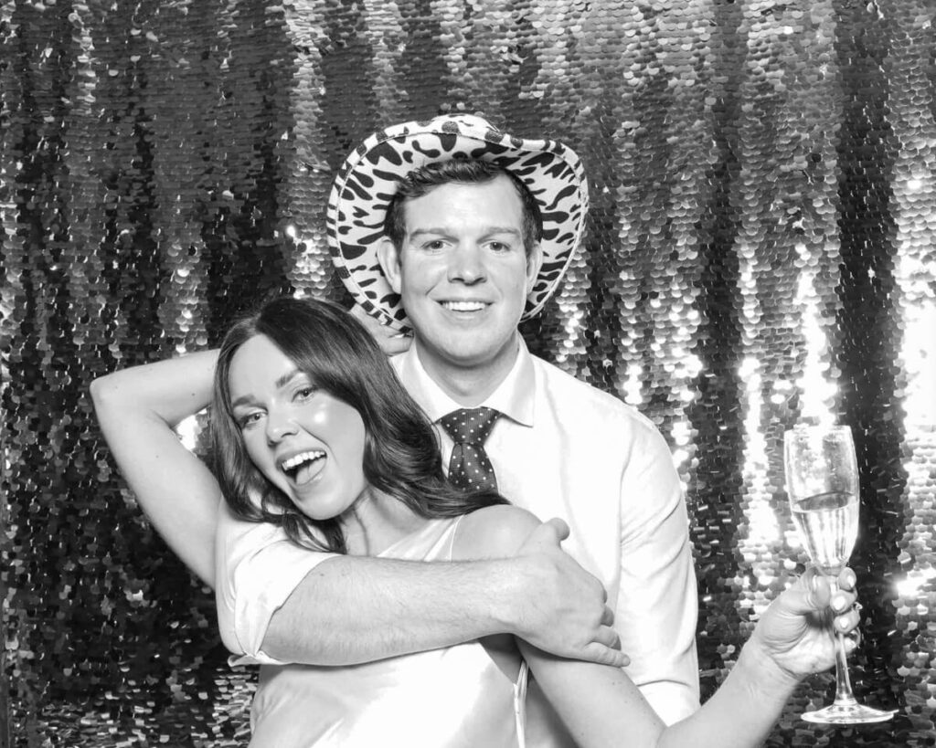 couple posing for mad hat photo booth rental for a corporate event photo booth rental