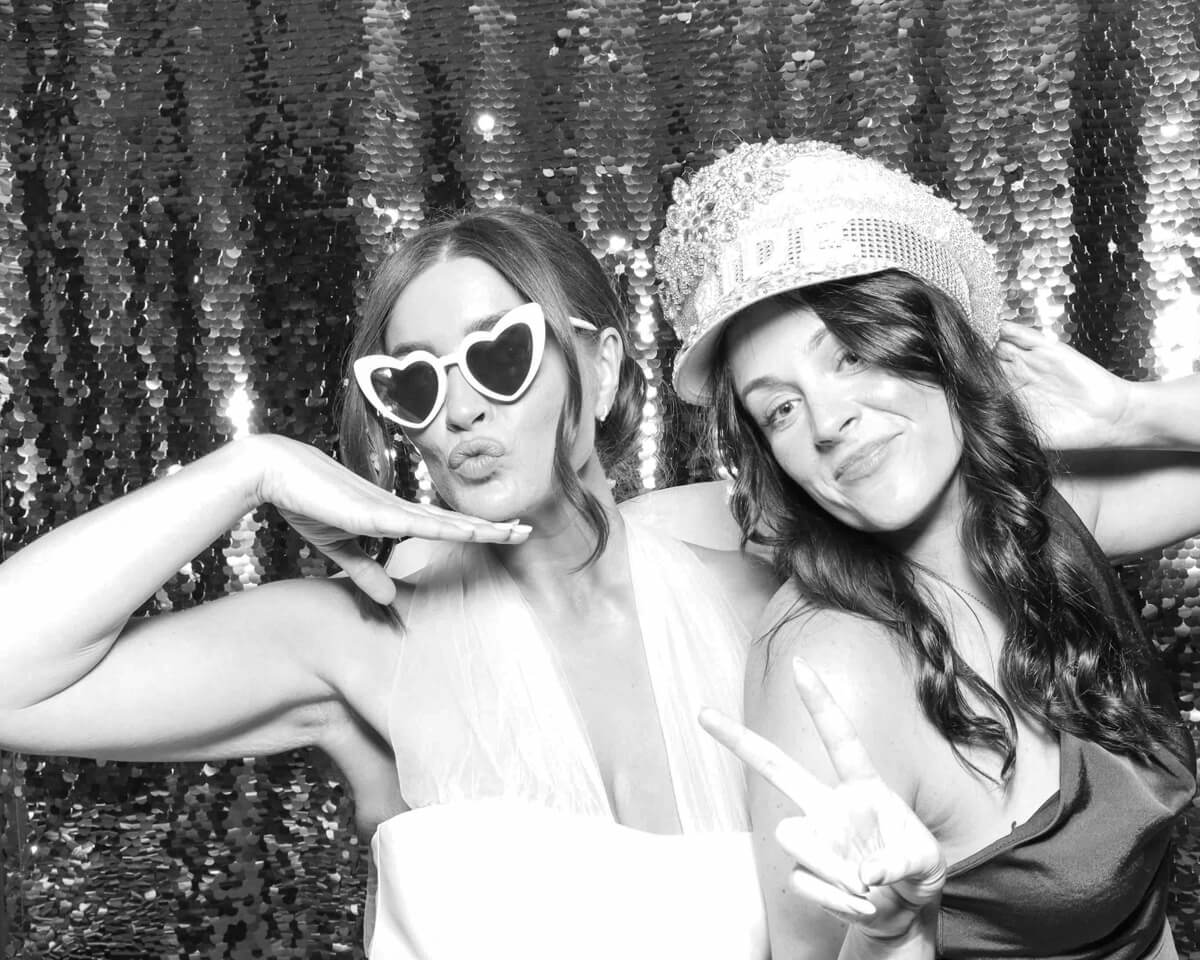 bridesmaids and bride with silver backdrop during a wedding party entertainment with mad hat photo booth in oxford