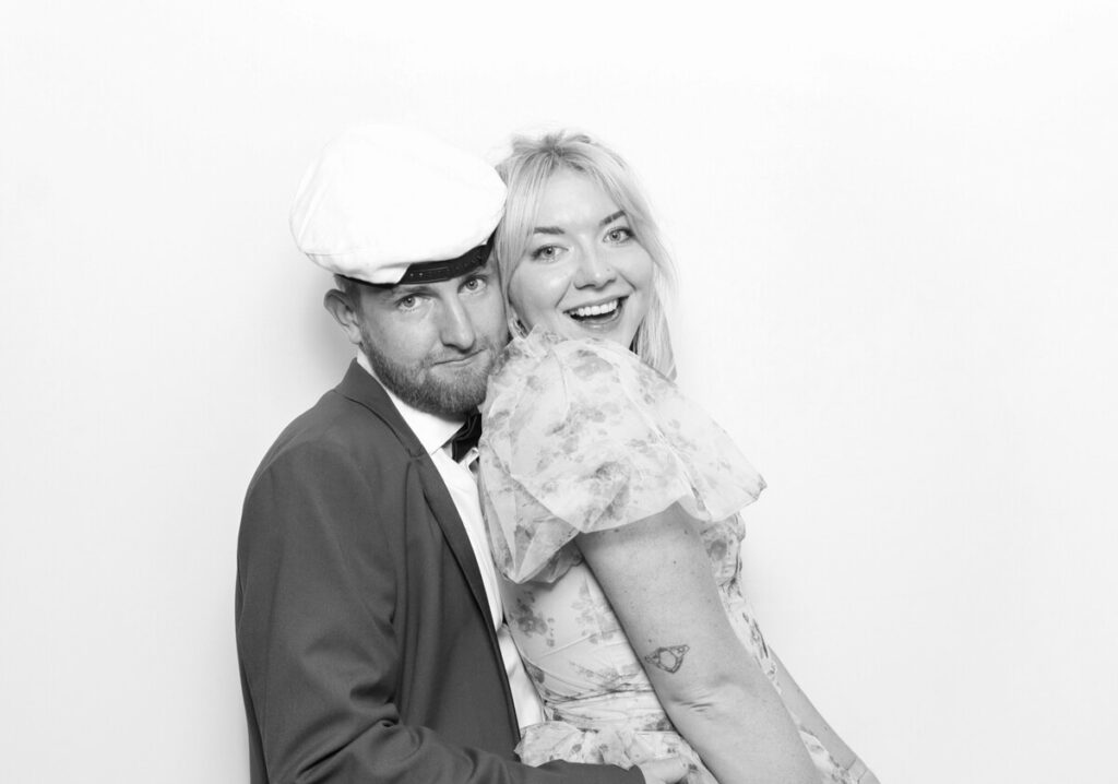 couple posing against a white backdrop for a luxury kin house wedding 