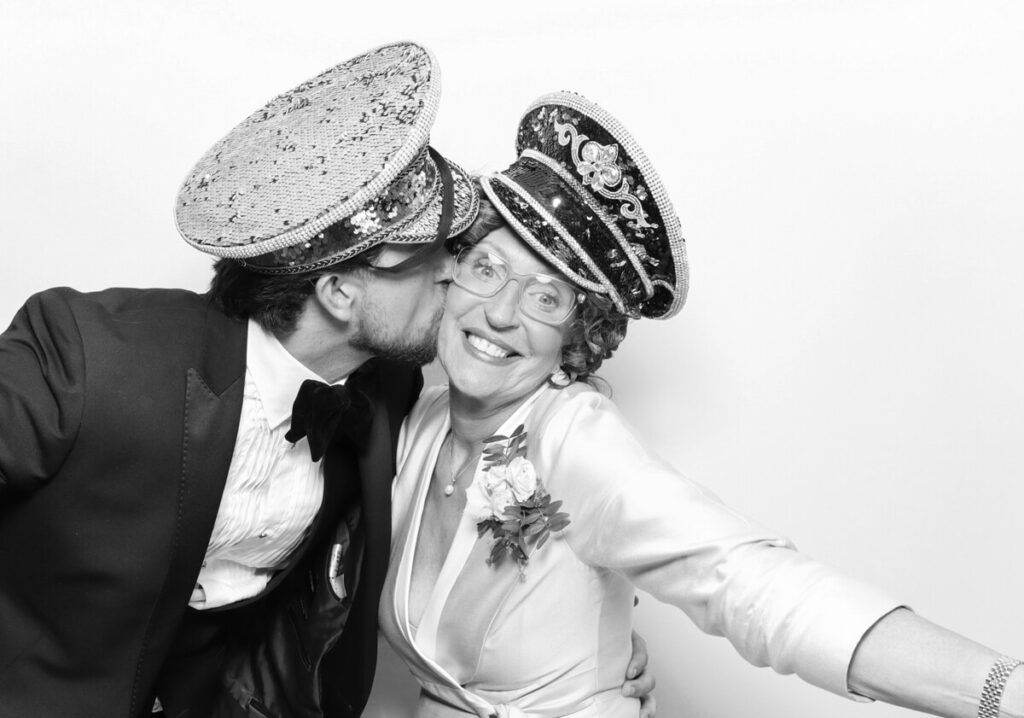 funny image of 2 people posing against a white backdrop for the party entertainment during the reception for a luxury venue