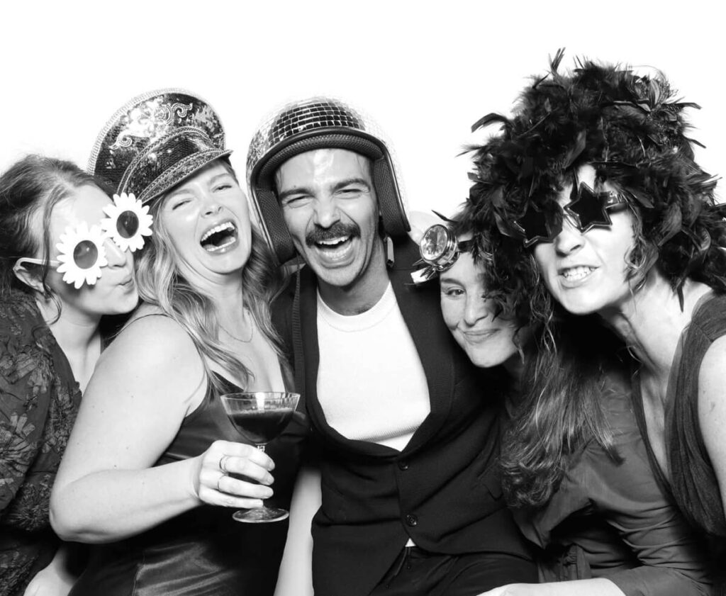 black and white image with the kardashian filter on of 5 guests wearing fun props during a luxury Photo Booth hire in the Cotswolds