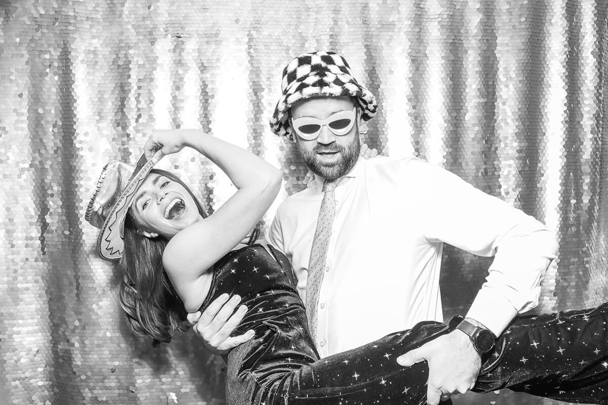 Black and white image of guests posing for Cotswolds photo booth hire for weddings and corporate events