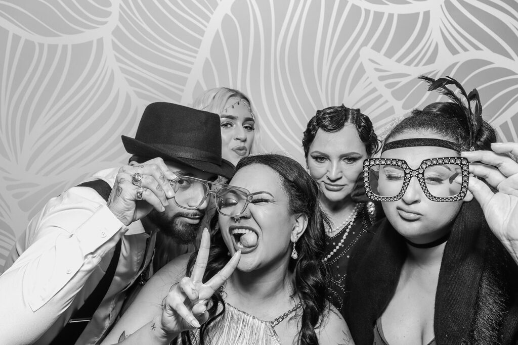 b&w picture of group of guests posing during a retro themed event party entertainment in the Cotswolds, Oxfordshire, Gloucestershire

