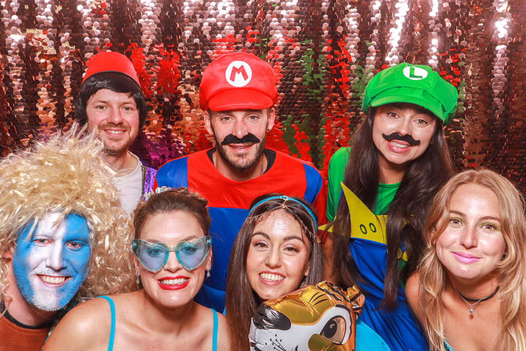 large group of guests posing during a fun themed birthday party photo booth entertainment in the Cotswolds, Oxfordshire, Gloucestershire
