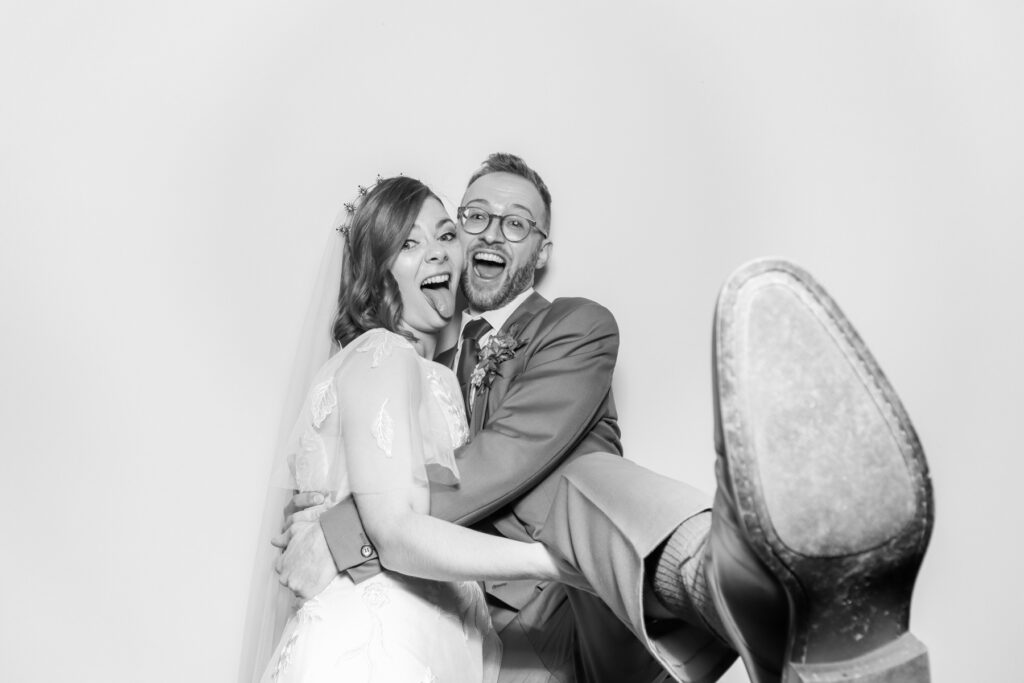 bride and groom posing with a b&w filter for kardashian style selfie pod hire for a cheltenham photo booth hire affordable party entertainment