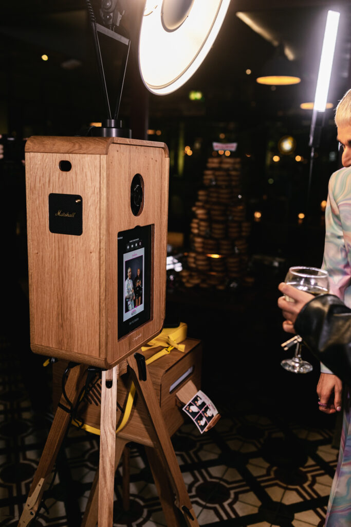 icon photo booth, an open photo booth setup with a wooden photo booth and a wooden case for the printer station, with a black sequins backdrop, during a private event in the cotswolds