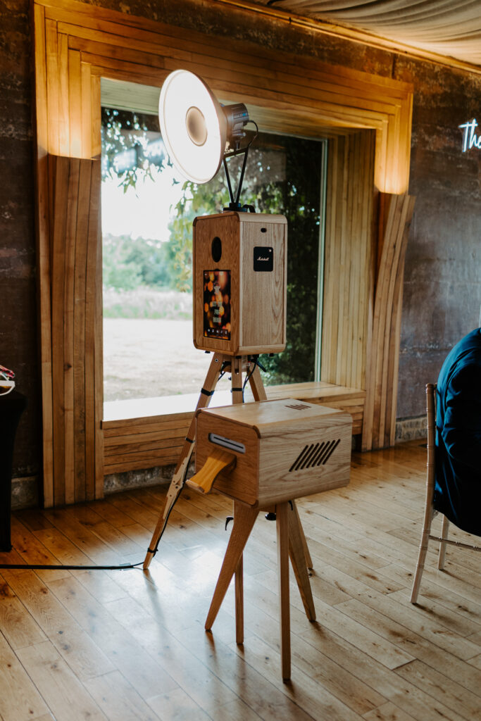 icon photo booth, an open photo booth setup with a wooden photo booth and a wooden case for the printer station, at a gloucestershire wedding venue , elmore court near Gloucester
