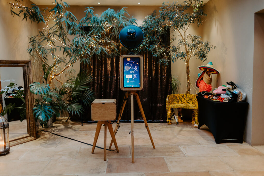 icon photo booth, an open photo booth setup with a wooden photo booth and a wooden case for the printer station, with a black sequins backdrop, at a cotswolds wedding venue , matara center near Gloucester