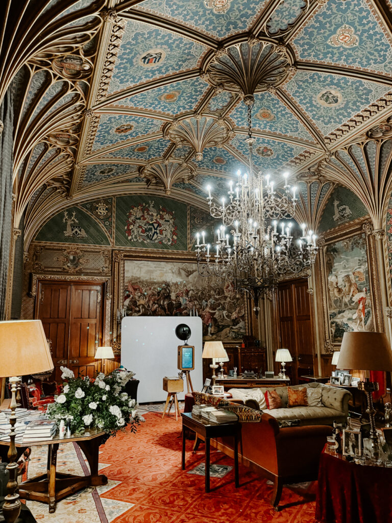 Eastnor Castle wedding venue with The Icon Photo Booth in place. Elegant historic interiors, chandelier, and luxury décor showcasing premium photo booth setup.