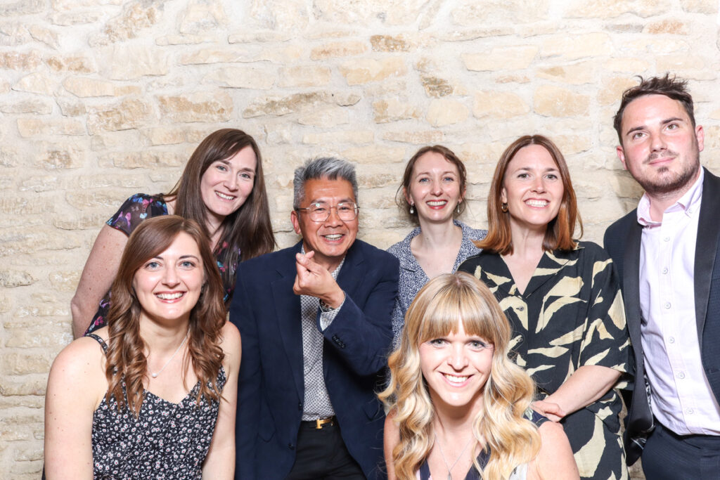 Smiling group of guests at a formal event using the iPad photo booth