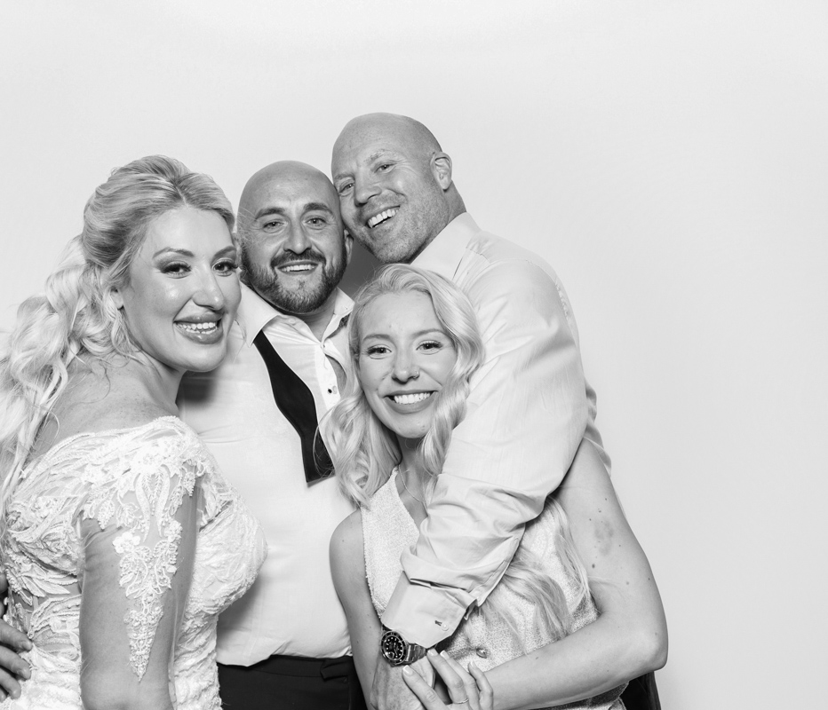 bride and guests hugging during a wedding event for the armada house photo booth with b&w filter during the best party entertainment in Bristol