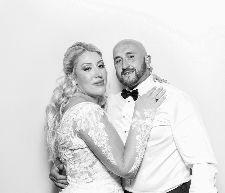 bride and groom posing against a white backdrop, for the best bristol party entertainment with the B&W kardashian style prints