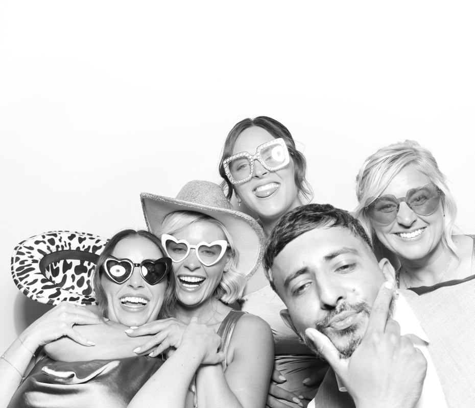 B&W image of guests posing for a premium photo booth rental at Ivy Lodge wedding venue Cirencester
