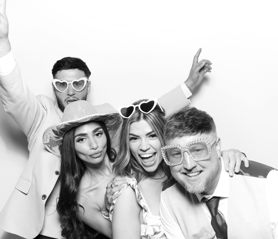 B&W image of guests posing for a premium photo booth rental at Ivy Lodge wedding venue Cirencester
