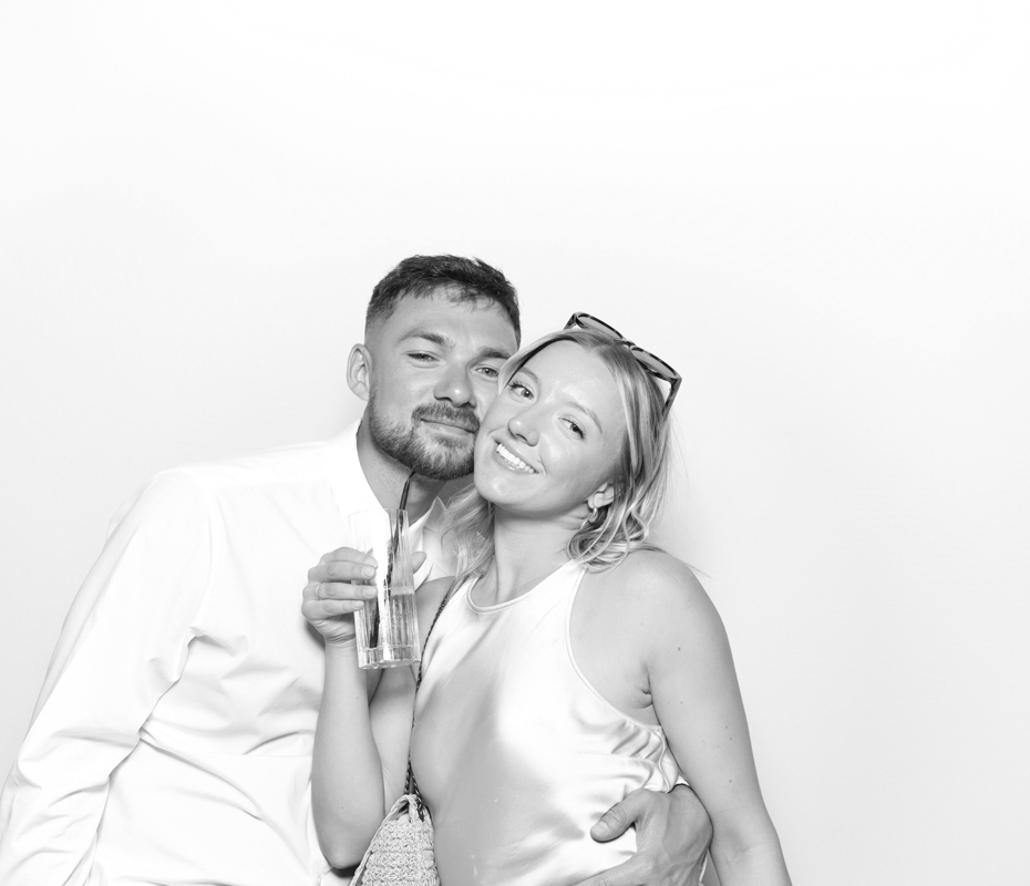B&W image of guests posing for a premium photo booth rental at Ivy Lodge wedding venue Cirencester
