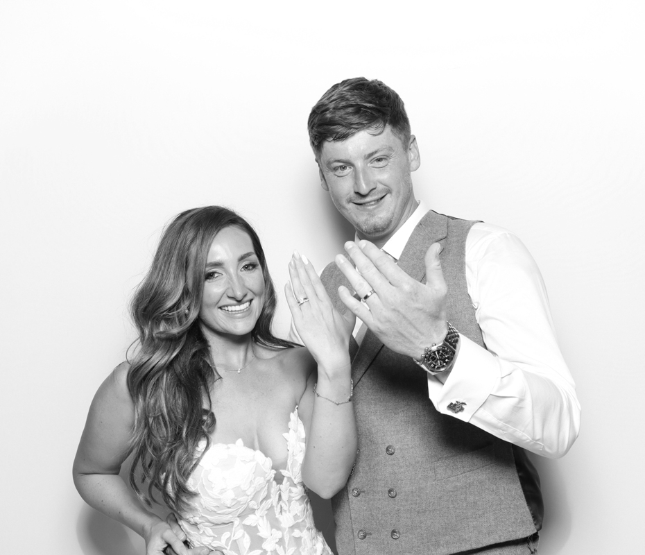 bride and groom showing off their wedding bands at Ivy lodge photo booth hire in cirencester
