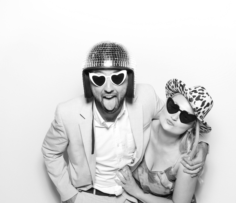 B&W image of guests posing for a premium party entertainment rental 
in Cirencester
