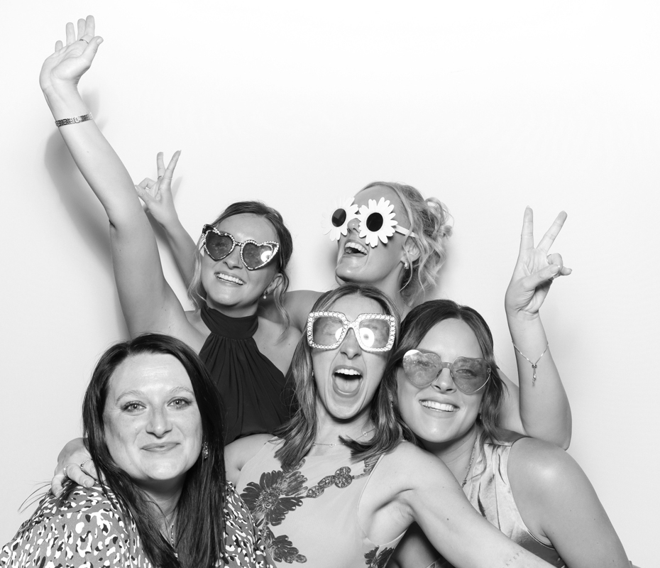 B&W image of guests posing for a premium photo booth rental at Ivy Lodge wedding venue Cirencester
