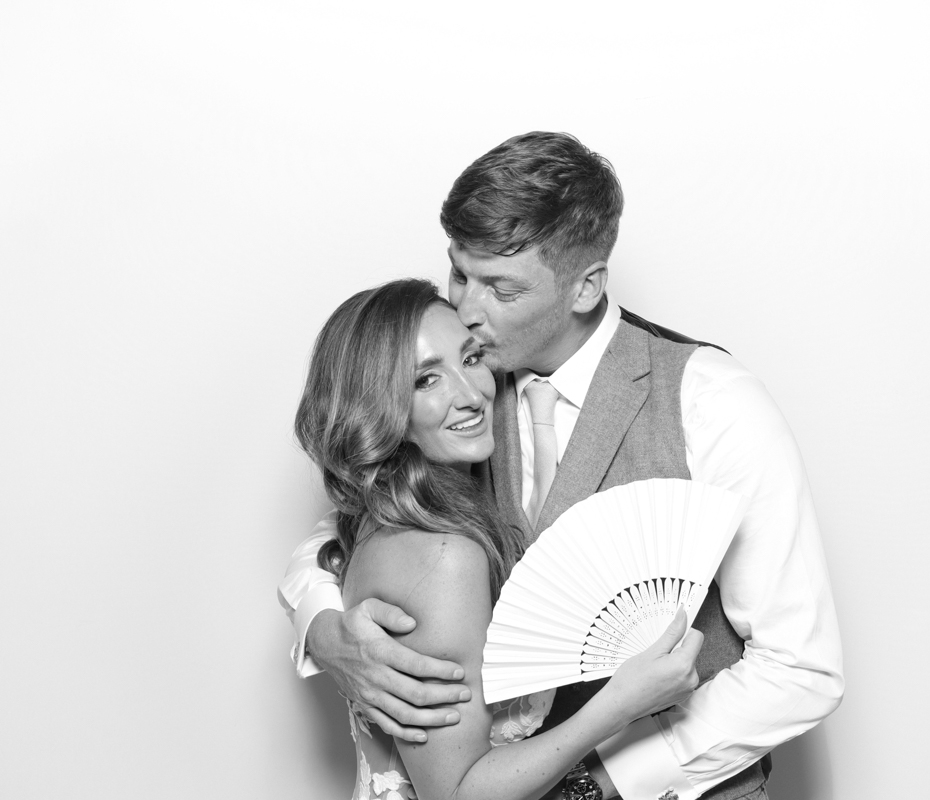 B&W kardashian style photo booth hire with bride and groom posing for mad hat photo booth 