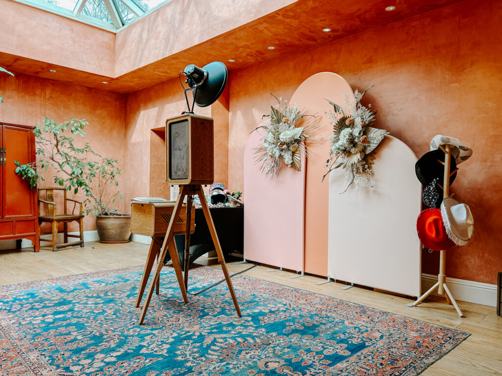 Luxury modern photo booth setup by Mad Hat for Asian weddings with boho flower wall and prop station and the Icon premium photo booth for hire