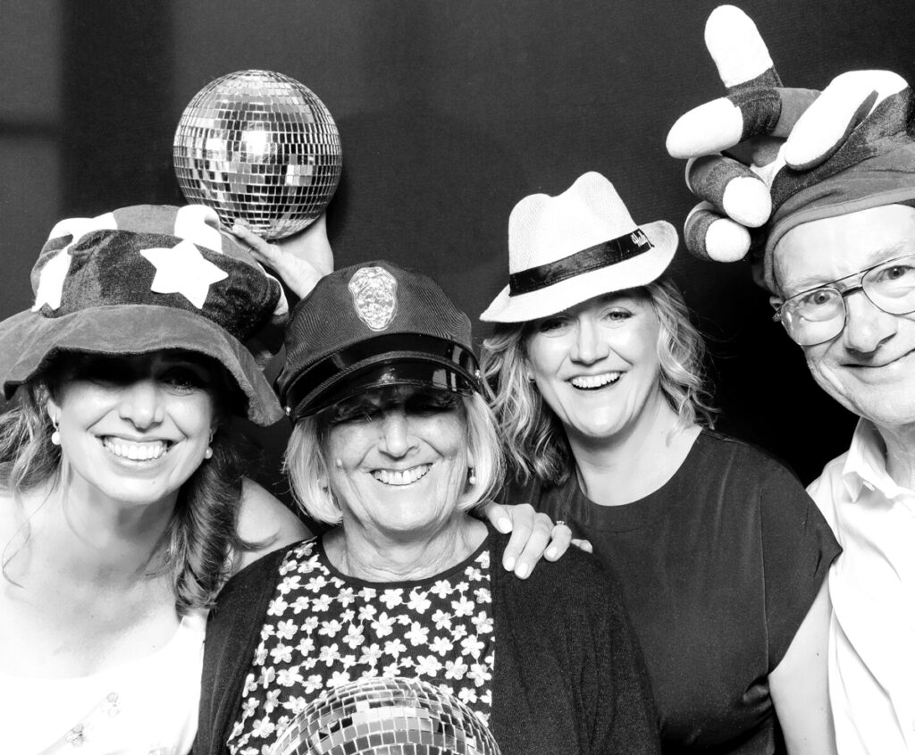 B&W image of a group of guests posing during a wedding party entertainment at The Painswick hotel in stroud 