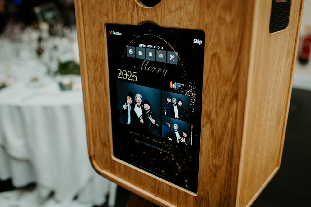 Front view of the Icon with “Merry Christmas 2025” display on the screen, set up for a festive company event.