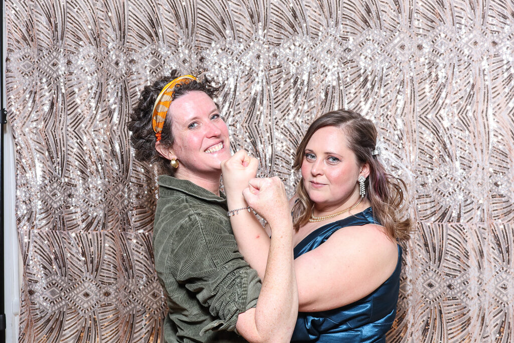 2 ladies posing for a Birthday Party PhotoBooth rental with a 1940s Twist with mad hat photo booth