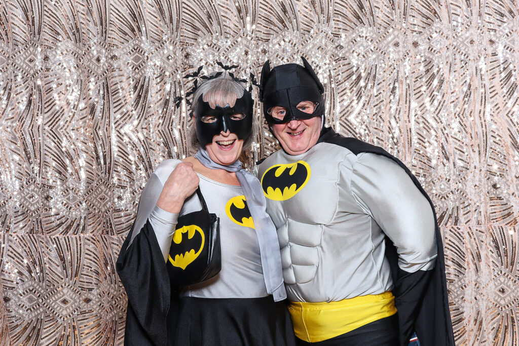 2 guests dressed up for an 1940s birthday party theme, with a sequins backdrop on the back, for a 40th birthday celebration